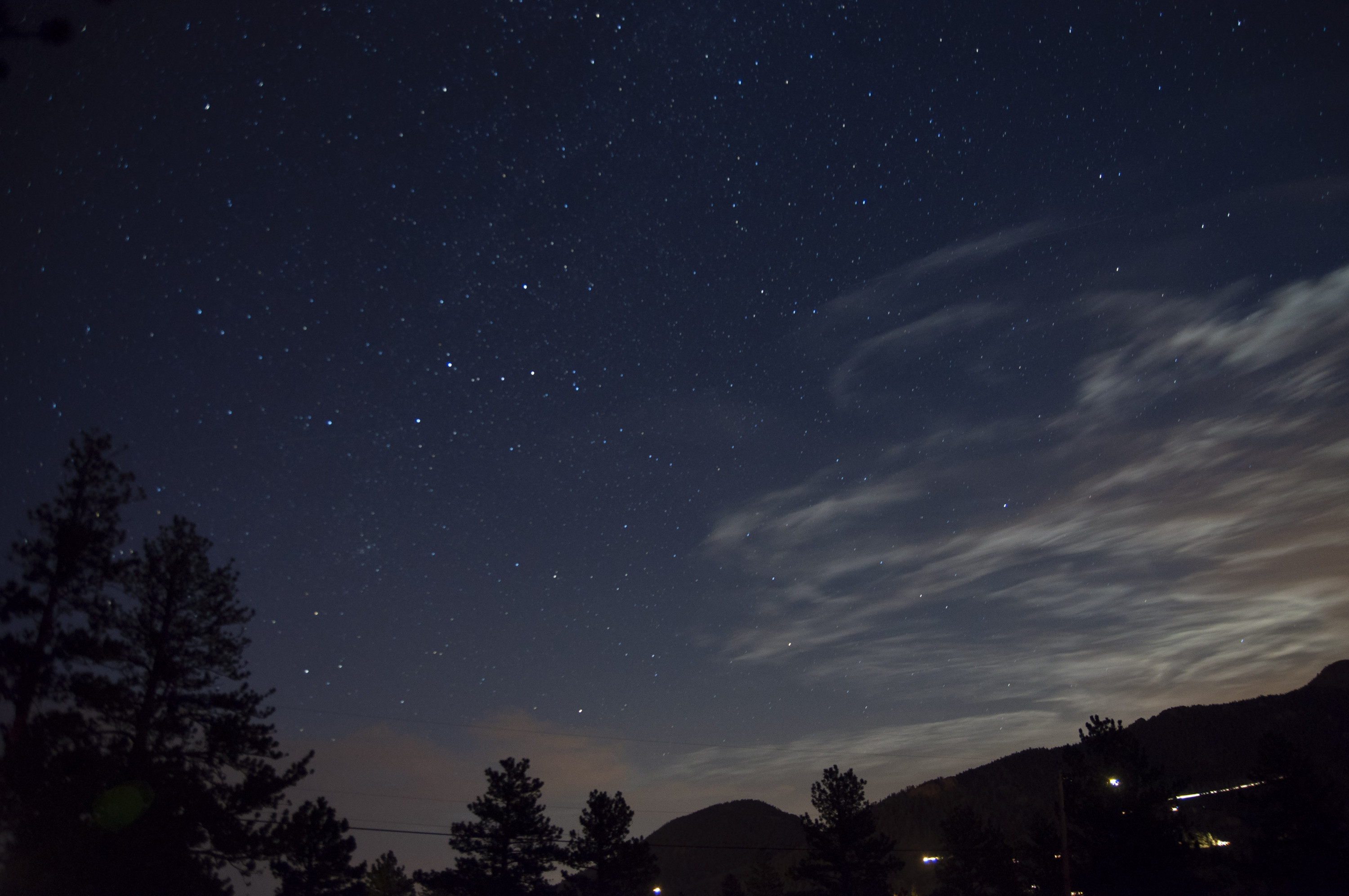 Clouds wisp around a starry sky in Colorado at YMCA of the Rockies in August 2013.